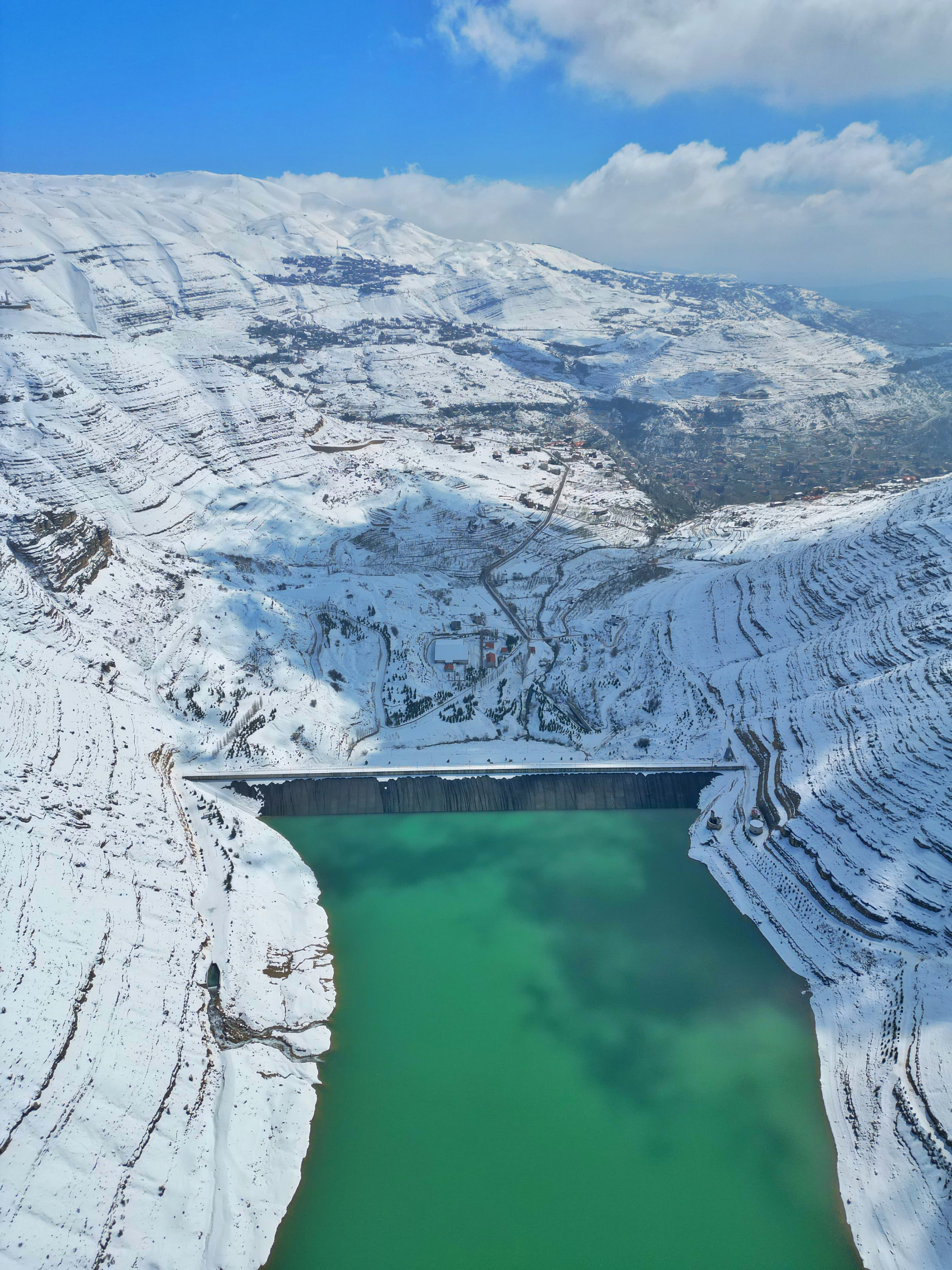 Turquoise Shabrouh Dam and snowy Faraya mountains — LebPar tour destination